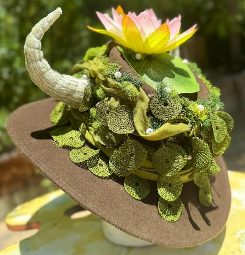 Upcycled metals and jewelry pieces around base of the horn + crown area between antlers.