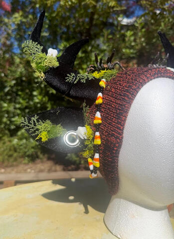 Black and orange heather-striped beanie (inside lined with black fleece) with black ears and black antlers.