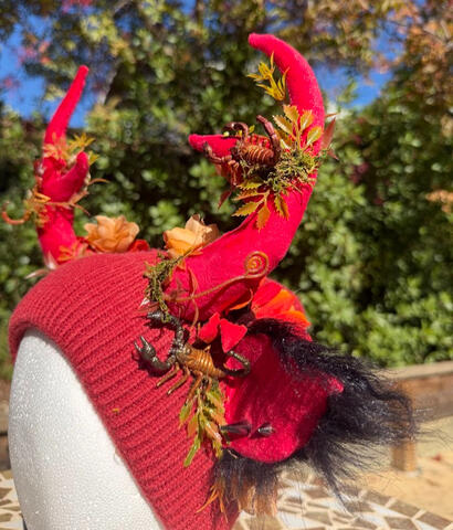 Moss &amp; desert-colored flora decorate the antlers.