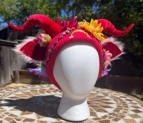 Upcycled bright red beanie with rainbow embroidery and matching red mini faun horns. Horns are poseable, ears are pierceable and bendable. This beanie does NOT have an inner lining.