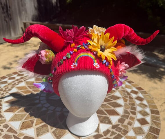 Multicolor beads decorate the front of the beanie, interlocked at the center for security.