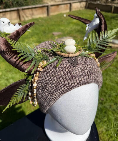 Small decorative copper piece peeks out from the bird's nest!