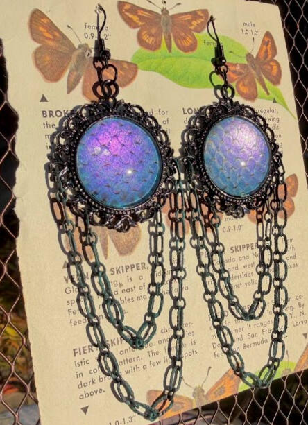 Black metalware w/ teal weathered chain accents. Deep purple-blue metallic shift snake shed. Black fish hooks. Approx 4&quot; length w/ some weight to them! $30
