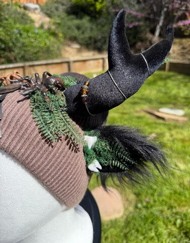 Beanie is lined on the inside with a soft black plush fleece. A silver chain with brown beads wrap around each antler. Horns are pose-able, ears are poseable / bendable.