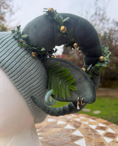 A strand of pine grows from each inner ear. This soft fleece fabric is a muted green with golden flecks throughout. See video for the full effect!