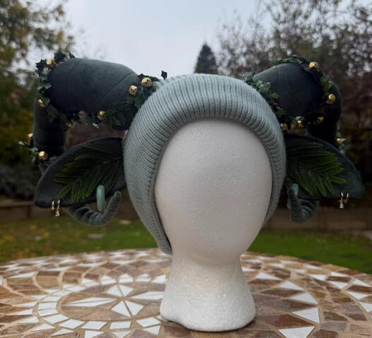 Pale sage green (white fleece lined) beanie with soft forest green faun horns and ears. A strand of ivy leaves and gold bells decorate each horn -- they are adjustable &amp; removable if desired !