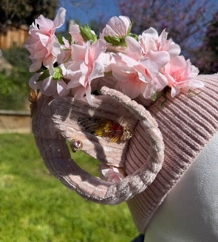 The top of the beanie features a gold metal floral accent with a light pink 3D silk butterfly. Horns are pose-able, ears are pierceable & bendable.