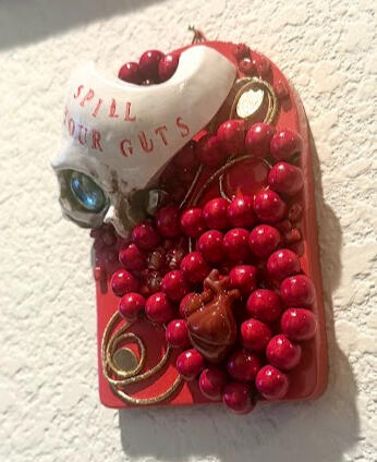 ceramic skull, marble, gold cabochons, gold chain, wood red beads, faux anatomical heart, glass beads