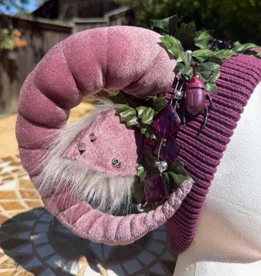 Ears are mauve with fluffy grey backing with silver studs and snail jewelry stud. A small Japanese rhinoceros beetle perches on either side of the beanie.